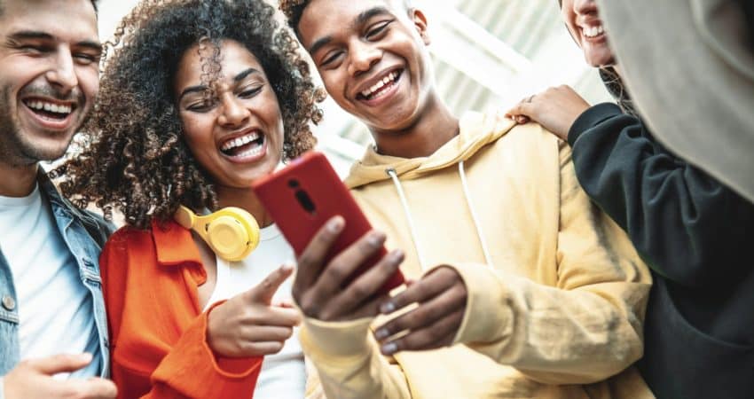Young people using smart mobile phone device outdoors